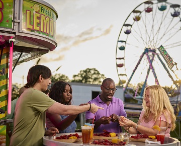 Friends sharing a meal in an amusement park in Lousiana